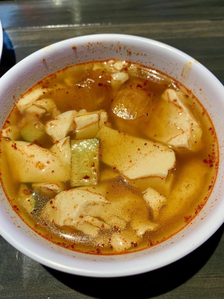 Korean Spicy Tofu Soup · The dish is made with freshly curdled soft tofu, vegetables, and gochujang or gochu garu.