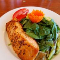 Spinach Salad · Baby spinach, Granny Smith apples, grape tomatoes, fresh basil, roasted leeks topped with cr...
