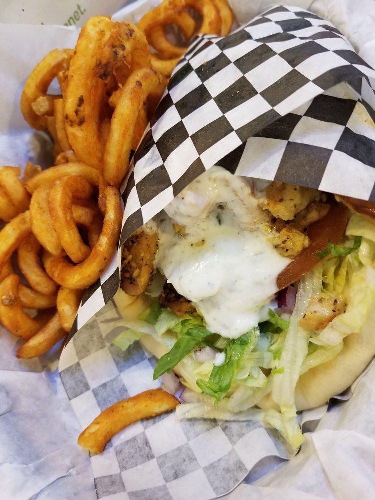 Chicken Shawarma Gyro · Sliced chicken breast sauteed in our special shawarma spices (not spicy). Served in a warm pita with lettuce, tomato, onion, pickles, and tzatziki sauce. 

Add optional Spicy Garlic, Feta Cheese and Hummus with some curly fries to complete your meal.