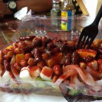 Tostilocos · Topped with cucumber, jicama, cueritos, chaca chaca, Japanese style nuts, mango, chamoy, sal...
