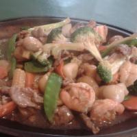Triple Delight House Specialty · Shrimp, scallops, and beef tenderloin with vegetables served on a sizzling platter.