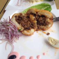 Papa Rellena · Potato dough with a filling made of ground beef, onions and Peruvian spices. Served with sal...