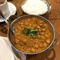 Chana Masala · Garbanzo beans sauteed and cooked in a combination of tomatoes, onions and spices. Garnished...