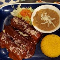 Mole Enchiladas · 3 corn tortilla filled with chicken and topped with mole.