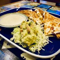 Quesadilla · Flour tortilla filled with cheese served with guac and sour cream.