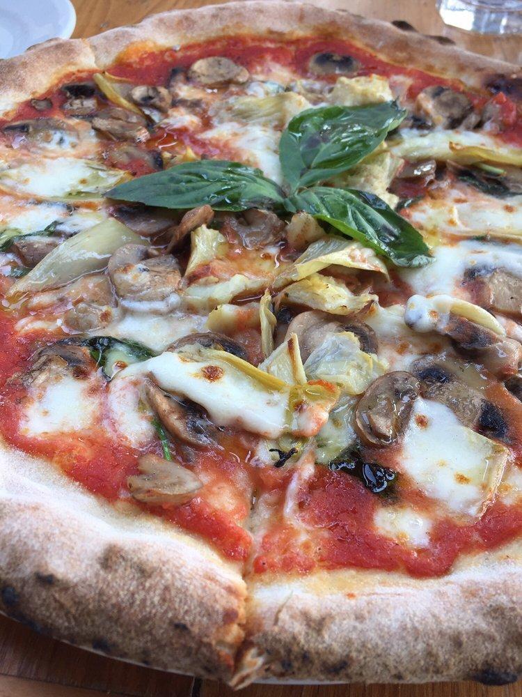 Capricciosa Pizza · Tomato sauce, fior di latte mozzarella, artichokes, mushrooms and black olives.