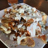 Buffalo Chips · Homemade potato chips drizzled with Buffalo sauce and blue cheese dressing.
