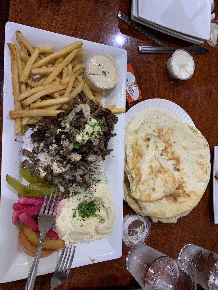 Beef Shawarma Plate · Beef shawarma, fries, tahini sauce sesame paste, pickles, tomatoes, onions and pita bread.