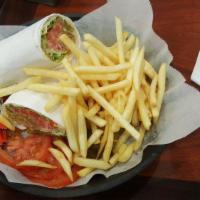 Falafel Wrap · Falafel, tahini sauce sesame paste, fresh tomatoes, pickles and romaine lettuce. Served with...
