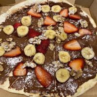Nutella Pizza · Nutella, strawberries, bananas, walnuts and powdered sugar.