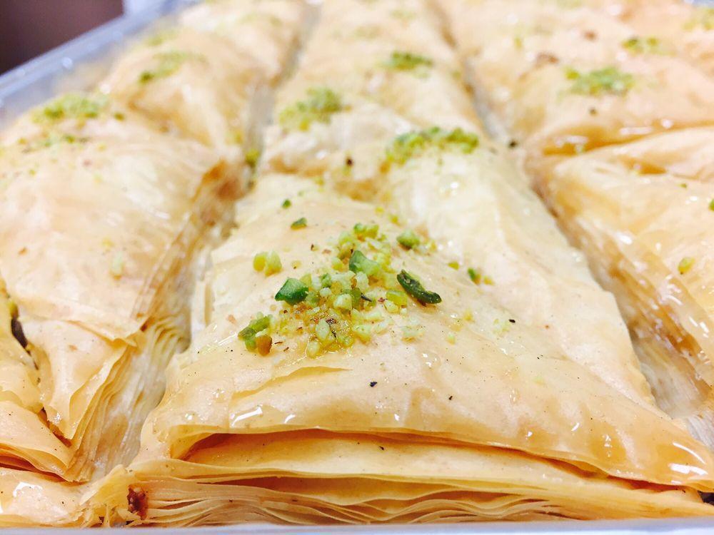 Baklava · Delicate layers of filo pastry filled with walnuts and pistachios moistened with a light sugar syrup.