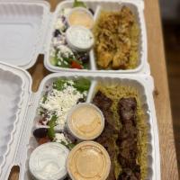 Lamb Gyro Plate · Freshly shaved lamb and beef slices served with basmati rice and Greek salad. Add bread for ...