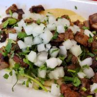 Asada Taco · Topped with onion and cilantro.