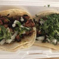 Al Pastor Taco · Topped with onion and cilantro.