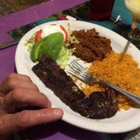 Carne Asada Steak · Tender skirt steak grilled to perfection, served with lettuce, tomatoes, sour cream, sliced ...