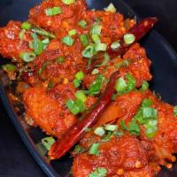 Chicken 65 · Tender crispy chicken cooked with curry leaves, tamarind and chili peppers.