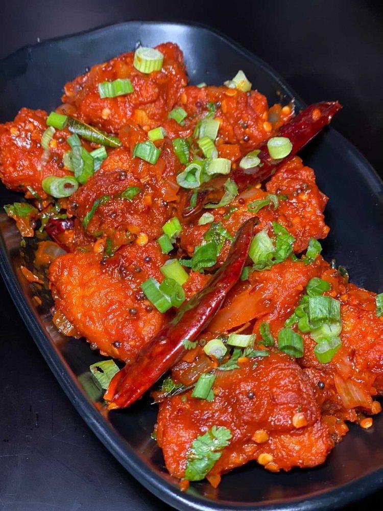 Chicken 65 · Tender crispy chicken cooked with curry leaves, tamarind and chili peppers.