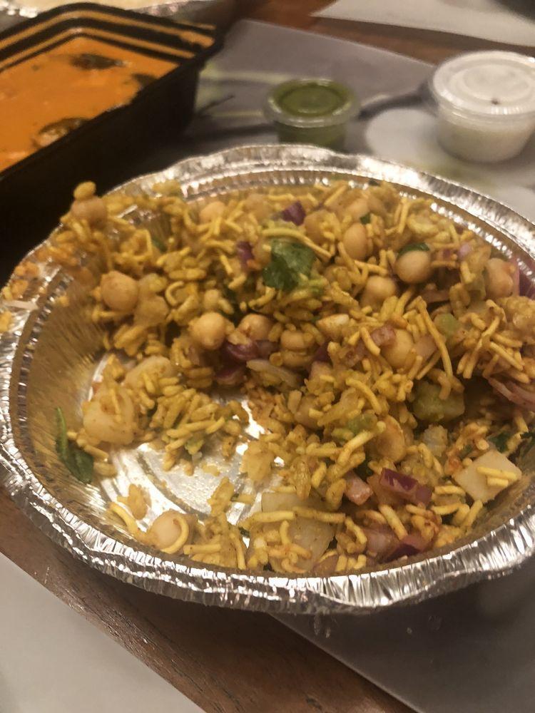 Bhel Poori · Tangy mixture of pulled rice with potatoes, onions, cilantro, green chilies tossed with tamarind and mint chutney.