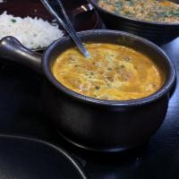 Dal Makhani · Black lentils cooked with fresh tomatoes and garlic, simmered overnight and topped with crea...