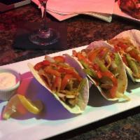 Escovitch Fish Tacos · Includes deep fried whiting layered with pickled onion and carrot drizzled with a scotch bon...