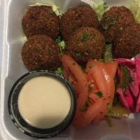 Falafel Platter · Fried veggie patties served on a bed of lettuce with tomatoes, parsley, pickles and a side o...
