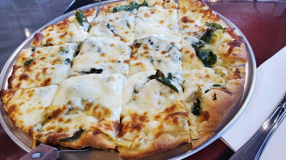 Thin Crust White Pizza · Olive oil, spinach, garlic, artichoke, topped with mozzarella.