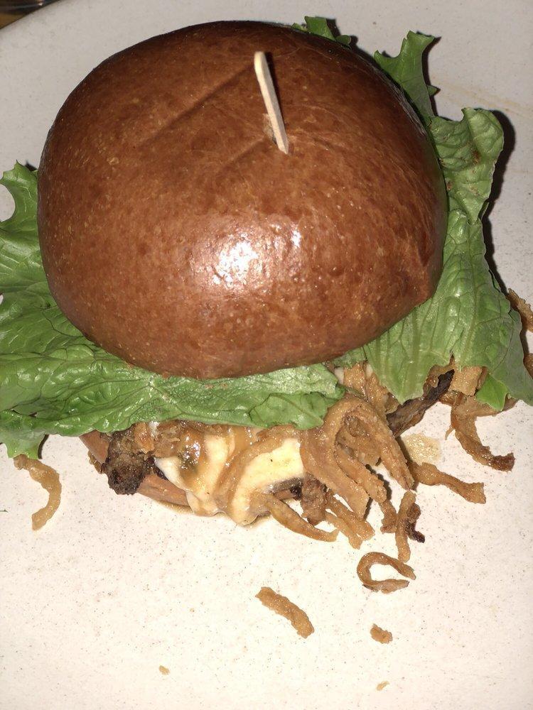 French Onion Burger · Organic grass fed beef, onion soup, emmental, cheddar fondue, onions rings and lettuce.