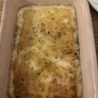 Saganaki · Baked imported kefalotiri cheese with lemon and oregano.