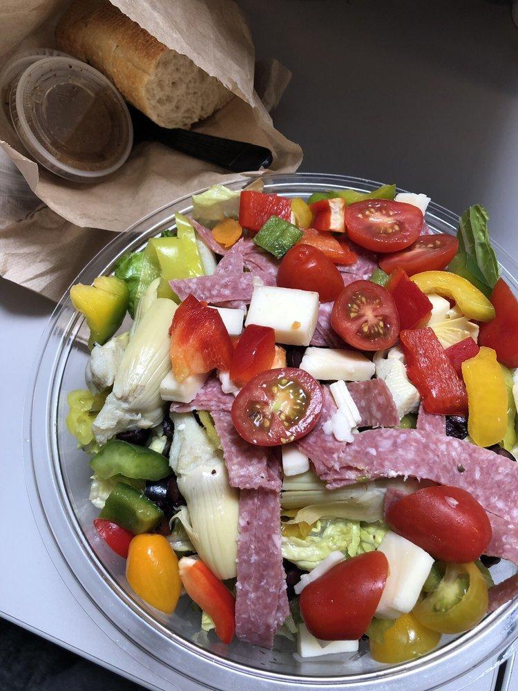 Italian Salad · Chopped romaine, red peppers, salami, mozzarella, Kalamata olives, tomatoes, artichoke hearts, pepperoncinis, Italian dressing, served with sourdough bread.