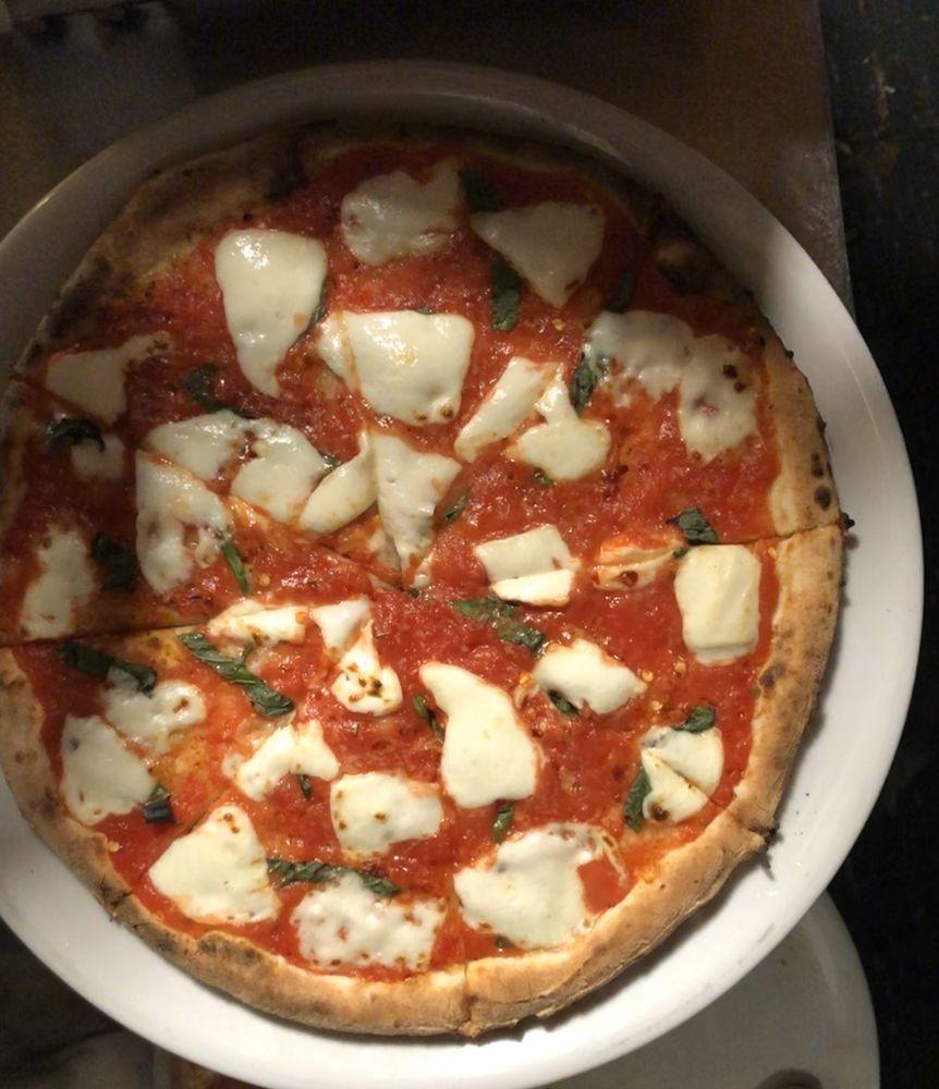 Margherita Pizza · Fresh mozzarella, pomodoro, basil, extra virgin olive oil, and Grana Padano.