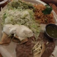 Flautas · 3 flautas de pollo with grated cheese, sour cream and guacamole, served with Mexican rice an...