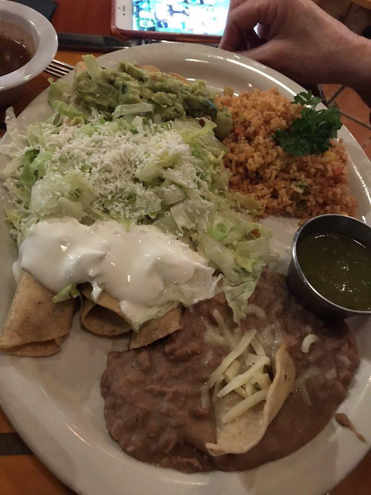 Flautas · 3 flautas de pollo with grated cheese, sour cream and guacamole, served with Mexican rice and refried beans.