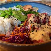 Tuna Poke Bowl · Ahi tuna, rice, wakame, edamame, cabbage, wasabi, ginger and miso-soy vinaigrette.