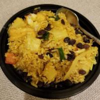 Pineapple Fried Rice · With egg, onion, pineapple and raisin in a light curry flavor.