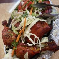 Tandoori Chicken · For this famous indian dish that we marinate our spring chicken in a blend of Punjabi authen...