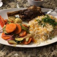 Lamb Shank · Tender lamb shank braised with Middle-Eastern spices. Served with basmati rice and sauteed v...