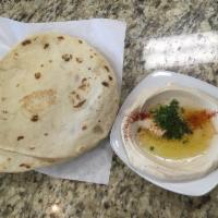 Hummus Plate · Creamy mixture of garbanzo beans. Garnished with olive oil and parsley. Served with fresh ba...