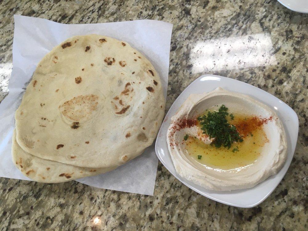 Hummus Plate · Creamy mixture of garbanzo beans. Garnished with olive oil and parsley. Served with fresh baked flatbread. Vegetarian. Gluten free.