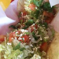 Grilled Shrimp Taco · Soft or crispy. Topped with lettuce, tomatoes, shredded cheese, cilantro, feta and garlic sa...