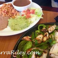 Fajitas · Grilled with vegetables, served with rice, beans, cheese, sour cream, guacamole, garnish and...