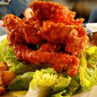 Buffalo Chicken Salad · Fried chicken tenders tossed in Buffalo hot sauce, served over romaine, topped with honey sm...