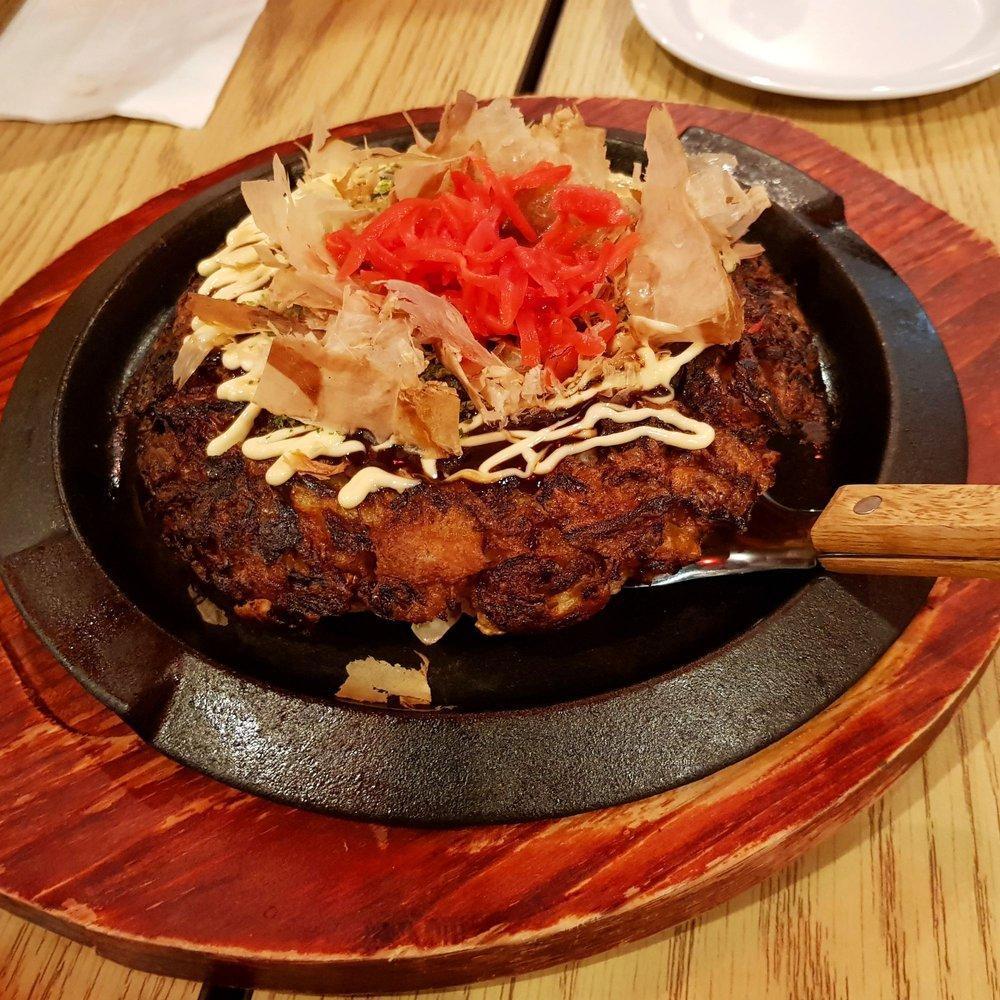 Okonomiyaki · Osaka style Japanese savory pancake filled with meat and vegetables, garnished with red pickled ginger and dry shaved bonito flake on top. Your choice of chicken, pork, shrimp or vegetarian.