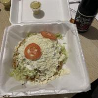Sope · Refried beans, queso fresco, lechuga, sour cream and your choice of beef or chicken fajita, ...