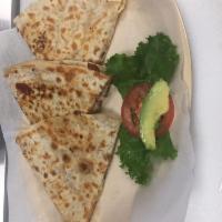 Quesadillas · Flour tortilla filled with melted cheese, and your choice of beef or chicken fajita.