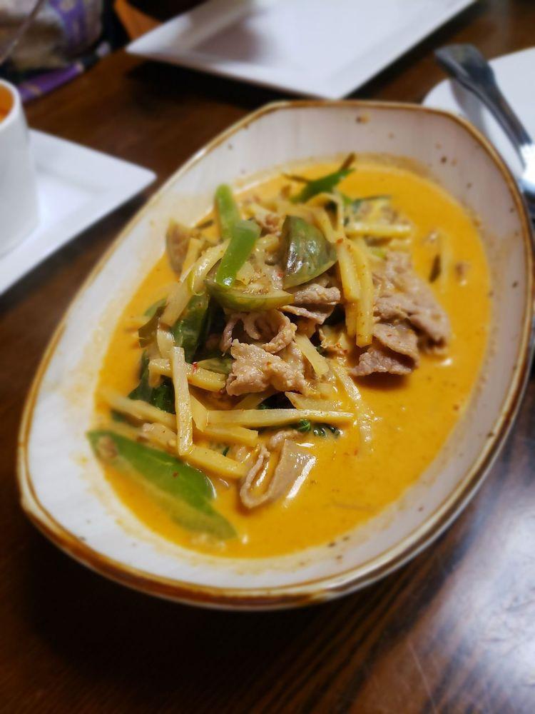 Thai Red Curry · Medium spicy curry in coconut milk, Thai eggplants, Thai basil, kaffir lime leaves, bell peppers & bamboo shoots.