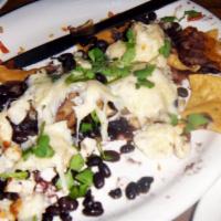 Nachos Azteca · Baked with chihuahua cheese spiced and marinated grilled chicken, black beans and cilantro (...