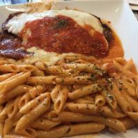 Eggplant Parm · Topped with Parmesan cheese and served with pasta. Includes soup or salad.