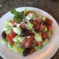 Greek Salad · Served with chopped hearts of romaine with English cucumbers, Roma tomato, feta cheese and K...