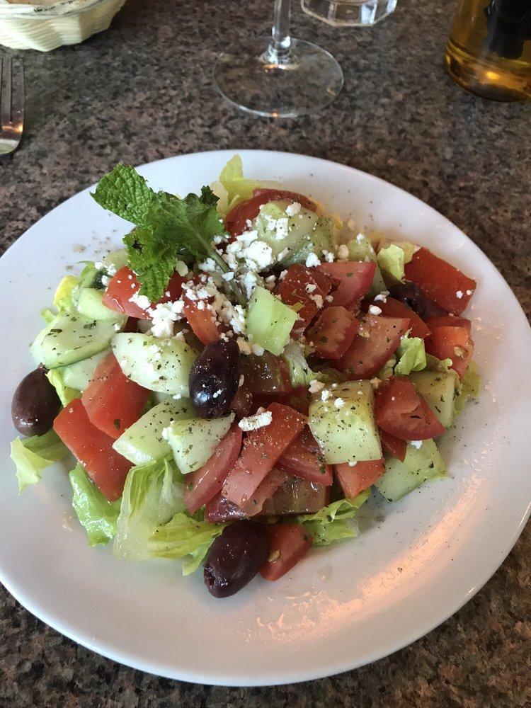 Greek Salad · Served with chopped hearts of romaine with English cucumbers, Roma tomato, feta cheese and Kalamata olives in a fresh lemon mint dressing.