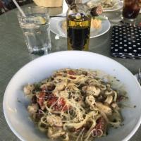 Linguine · Served with sauteed chicken breast, wine, garlic and sun-dried tomatoes in a light pesto cre...